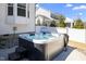 Backyard hot tub is perfect for relaxation and entertaining, set on a stone surface with privacy fence at 2632 Jordan Pointe Blvd, New Hill, NC 27562