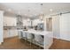 Spacious kitchen with a large island, white cabinets, stainless steel appliances, and a tile backsplash at 2632 Jordan Pointe Blvd, New Hill, NC 27562