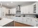 Well-lit kitchen with white cabinetry, modern appliances, and hardwood flooring at 2632 Jordan Pointe Blvd, New Hill, NC 27562