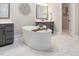 Bright bathroom features a soaking tub with wood caddy, marble floors and modern fixtures at 2632 Jordan Pointe Blvd, New Hill, NC 27562