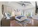 Tranquil main bedroom showcasing a bay window, tray ceilings and hardwood floors at 2632 Jordan Pointe Blvd, New Hill, NC 27562