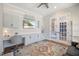 Bright office space with built-in desk, cabinetry, and decorative rug and an accent wall of horizontal wood panels at 2632 Jordan Pointe Blvd, New Hill, NC 27562