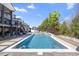 A luxurious backyard with a pool, lounge chairs, and a view of the well-maintained lawn at 2632 Jordan Pointe Blvd, New Hill, NC 27562