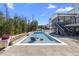 Inviting backyard oasis with a sparkling swimming pool, stylish lounge chairs, and patio area at 2632 Jordan Pointe Blvd, New Hill, NC 27562