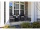 Cozy front porch with stone accents, classic columns, and comfortable seating area for relaxing at 2632 Jordan Pointe Blvd, New Hill, NC 27562