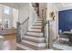 View of the entry foyer staircase with wrought iron spindles and wooden railing at 2632 Jordan Pointe Blvd, New Hill, NC 27562