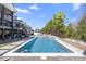 Sparkling swimming pool with lounge chairs and lush landscaping, a perfect oasis for relaxation at 2632 Jordan Pointe Blvd, New Hill, NC 27562