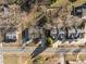 Aerial view of neighborhood with tree coverage, homes, and a street running through at 310 Chub Lake St, Roxboro, NC 27573