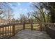 Wooden back deck showcasing a view of the backyard trees and foliage at 310 Chub Lake St, Roxboro, NC 27573