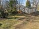 Large backyard with grass and view of back exterior of a home at 310 Chub Lake St, Roxboro, NC 27573