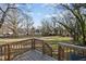 Spacious, tree-lined backyard viewed from a wooden deck, ready for outdoor enjoyment at 310 Chub Lake St, Roxboro, NC 27573