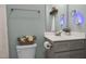 Neutral toned bathroom features a gray vanity and a toilet with decorative flowers at 310 Chub Lake St, Roxboro, NC 27573