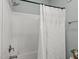 Clean white-tiled shower with modern shower head and decorative curtain at 310 Chub Lake St, Roxboro, NC 27573