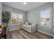 Bright bedroom featuring wood floors, a daybed, and natural light from two windows at 310 Chub Lake St, Roxboro, NC 27573