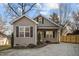 Charming home with gravel driveway, well-maintained landscaping, and neutral siding at 310 Chub Lake St, Roxboro, NC 27573