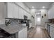 Modern kitchen with white cabinets, granite countertops, subway tile backsplash, and stainless steel appliances at 310 Chub Lake St, Roxboro, NC 27573