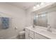 Bright bathroom with double sinks, quartz countertop, and tiled shower at 368 Amber Acorn Ave, Raleigh, NC 27603