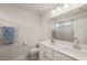 Modern bathroom with double sinks, quartz countertops, and a glass-enclosed shower at 368 Amber Acorn Ave, Raleigh, NC 27603