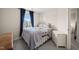 Comfortable bedroom with a large window providing natural light and blue curtains at 368 Amber Acorn Ave, Raleigh, NC 27603