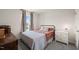 Cozy bedroom with a metal bed frame, window with curtains, and a white nightstand at 368 Amber Acorn Ave, Raleigh, NC 27603