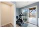 Bright exercise room with a Peloton bike and sliding glass doors leading to the outdoor deck at 368 Amber Acorn Ave, Raleigh, NC 27603
