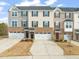 Charming townhome exteriors with attached garages and manicured lawns for convenient parking at 368 Amber Acorn Ave, Raleigh, NC 27603