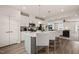 Open kitchen with island, stainless appliances, and adjacent living area at 368 Amber Acorn Ave, Raleigh, NC 27603