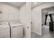 Convenient laundry room with modern washer and dryer, and wire shelving at 368 Amber Acorn Ave, Raleigh, NC 27603