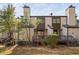 View of the exterior of this two story condo with wood siding, chimney, and back deck at 3775 Guess Rd # 36, Durham, NC 27705
