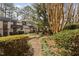 Beautiful community grounds showcase paved walkway, mature trees, and lush green bushes at 3775 Guess Rd # 36, Durham, NC 27705