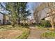 Manicured community grounds with paved walkway, large trees, lush bushes, and ground cover at 3775 Guess Rd # 36, Durham, NC 27705