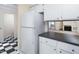 The kitchen has white cabinets and a view into the living room from the countertop at 3775 Guess Rd # 36, Durham, NC 27705