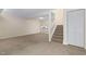 Living room features stairs to upper level and small view of kitchen at 3775 Guess Rd # 36, Durham, NC 27705