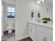 Bright bathroom featuring double sinks, modern fixtures, and a window providing natural light in the house at 380 Grameta Ln, Lillington, NC 27546