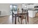 Bright dining room features wood floors, modern table and chairs, and sliding glass door to the backyard at 380 Grameta Ln, Lillington, NC 27546