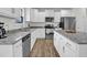 Modern kitchen featuring granite counters, stainless steel appliances, and hardwood floors at 380 Grameta Ln, Lillington, NC 27546