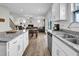 Modern kitchen flows into living room, granite counters, and stainless steel appliances at 380 Grameta Ln, Lillington, NC 27546