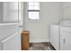 Well-lit laundry area with modern appliances, convenient shelving, and tile flooring, ready for your laundry needs at 380 Grameta Ln, Lillington, NC 27546