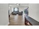 Light-filled living room with wood-look flooring, ceiling fan, and staircase at 380 Grameta Ln, Lillington, NC 27546