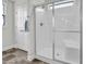 This main bathroom features a shower with glass doors, a linen closet, and a window at 380 Grameta Ln, Lillington, NC 27546