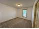 Bright bedroom with plush carpeting, white walls, and a window for natural light at 3901 Carson Dr, Sanford, NC 27332