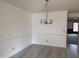 Bright dining room featuring stylish chandelier and new neutral flooring at 3901 Carson Dr, Sanford, NC 27332