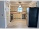 Bright kitchen featuring modern appliances, neutral cabinets, butcher block counters, and vinyl flooring at 3901 Carson Dr, Sanford, NC 27332