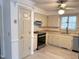 A well-lit kitchen featuring stainless steel appliances, neutral cabinets, and butcher block counters at 3901 Carson Dr, Sanford, NC 27332