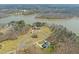 Aerial view showcases the home's location on a large lot with lake access and surrounding mature trees at 40 Park Meadow Ln, Youngsville, NC 27596