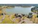 Aerial view of a lakefront property featuring multiple structures and extensive landscaping at 40 Park Meadow Ln, Youngsville, NC 27596