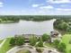 Aerial view of the lake house surrounded by lush greenery and a private lake at 40 Park Meadow Ln, Youngsville, NC 27596