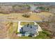 Aerial shot of a home surrounded by a large grassy area, mature trees and long driveway at 40 Park Meadow Ln, Youngsville, NC 27596
