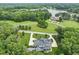 Beautiful aerial view of the luxury home featuring lush landscaping and circular driveway at 40 Park Meadow Ln, Youngsville, NC 27596