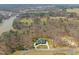 Aerial view of an estate home surrounded by mature trees and serene landscapes at 40 Park Meadow Ln, Youngsville, NC 27596